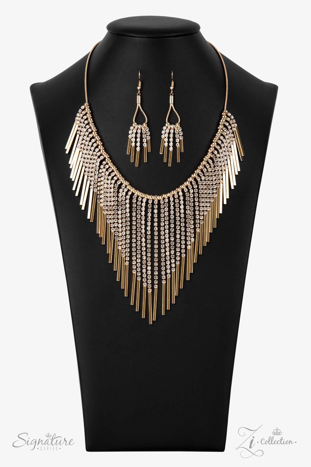 Paparazzi The Amber 2021 Zi Collection Gold Necklace Gold beads, strandsa of white rhinestones morph into gold rectangular frames along a snake chain. The golden getup stacks into tapered tassels, creating a fringe. ​Sold as one individual necklace. Includes one pair of matching earrings. Zi Collection Paparazzi